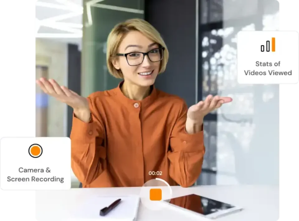 A cheerful woman in an orange blouse presenting something, with an overlay of camera and screen recording interface elements.